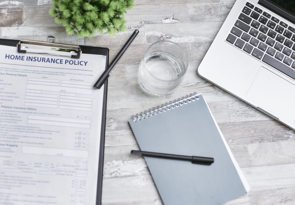 Extended health benefits policy paperwork on a desk, related to direct billing for acupuncture and massage therapy