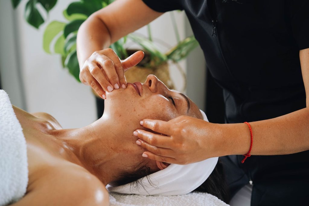 Calming facial massage session, similar to buccal facial massage used for jaw tension and TMJ relief